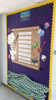 a bulletin board on the wall in a room with a green and white checkered blanket