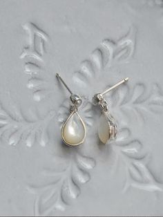 Composition : Silver (Sterling Silver 92.5%), Natural white mother-of-pearl, freshwater pearlColor : SilverCountry of Origin : KOREA Pearl Drop Earrings In Mother Of Pearl, Elegant Mother Of Pearl Earrings With Pearl Drop, Formal Pearl Earrings In Mother Of Pearl, Teardrop Mother Of Pearl Earrings For Formal Occasions, Formal Mother Of Pearl Earrings For Pierced Ears, Formal Mother Of Pearl Earrings, White Pearl Pendant Earrings In Mother Of Pearl, Mother Of Pearl Dangle Pearl Earrings, Elegant Mother Of Pearl Drop Earrings