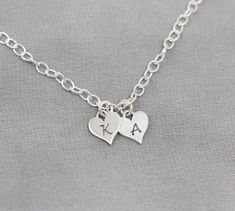 This sweet bracelet, featuring your initials engraved on Sterling Silver hearts, is sure to make her smile. Show her your love by personalizing this Sterling Silver bracelet as a thoughtful gift for a birthday, anniversary or Christmas. The Sterling Silver chain can be cut to your preferred length (standard is 7 1/2") and features an adjustable clasp so that she can adjust it to fit.TO ORDER -- Please select the initials that you would like from the drop down menus. Please include the length tha Heart-shaped Name Bracelet With Heart Charm For Personalized Gift, Personalized Heart Charm Name Bracelet, Personalized Sterling Silver Heart Bracelet, Heart Charm Name Bracelet For Personalized Gifts, Luxury Heart-shaped Name Bracelet For Personalized Gift, Personalized Sterling Silver Heart Friendship Bracelet, Personalized Heart-shaped Charm Bracelet, Personalized Heart Charm Bracelet For Friendship, Personalized Charm Bracelet For Friendship On Valentine's Day