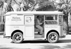 an old photo of a man sitting in the driver's seat of a food truck