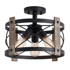 a light fixture with two lights on top of it and an open cage around the base