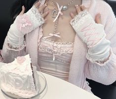 a woman wearing gloves and holding a piece of cake