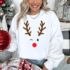 Celebrate the magic of the holiday season with our Christmas Reindeer Trompe l'Oeil Sweatshirt, the perfect blend of comfort and festive style. Our unisex reindeer face jumper is designed to keep you cozy and stylish during those chilly winter days. 🦌 Key Features: 🎄 Festive Design: This Christmas sweatshirt showcases a captivating trompe l'oeil reindeer face, adding a whimsical touch to your holiday wardrobe. 🧥 Premium Quality: Crafted from a soft and durable blend of materials, this sweatshirt offers warmth without compromising on comfort. 🎁 Perfect Gift: Looking for a unique holiday present? Our reindeer sweatshirt makes an excellent gift for friends, family, or even yourself! 🎅 Versatile Style: Whether you're attending a Christmas party, decorating the tree, or just enjoying a coz Cute Christmas Jumpers, Ugly Sweater Diy, Sweatshirt Colors, Reindeer Face, Diy Halloween Projects, Camp Style, Sewing Workshop, Holiday Apparel, Holiday Sweatshirt