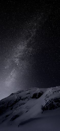 the night sky is filled with stars above a snowy mountain