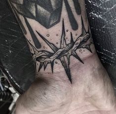 a black and white photo of a hand with tattoos on it