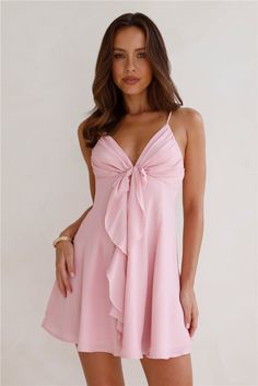 Length from shoulder to hem of size S: 73cm. Chest 35cm, Waist 30cm, across front only of size S. Mini dress. Lined. Model is a standard XS and is wearing size XS. True to size. Non-stretch. Bow with frill detail. V-neck. Flowy skirt. Shirred elastic back. Zipper. Cold hand wash only. Polyester/Spandex. We're in love with the Smile Back At Me Mini Dress. Featuring a gorgeous bow with a frill detail and a flowy skirt. Style with heels and curls for all the attention. Feminine Pink Mini Dress With Bow Tie Back, Pink Flowy V-neck Mini Dress, Pink V-neck Mini Dress With Tie Waist, Pink A-line Mini Dress With Bow, Pink A-line Mini Dress With Ruffles, Mini Dress Pink, Prom Shopping, Skirt Style, The Smile