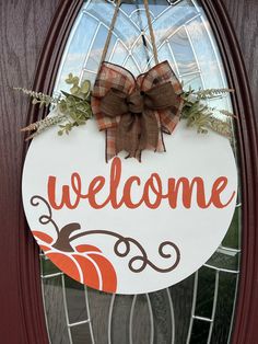 a welcome sign hanging on the front door