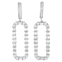 A sleek geometric design makes these earrings an impressive addition to any outfit. Diamond baguettes totaling 3.0 carats are paired with round-cut diamonds totaling 1.30 carats on this impressive pair of earrings. Each one features an 18K White Gold setting that measures 1.75 201D; long and 0.5 201D; wide. This jewelry piece is offered in estate condition and includes a gift box. White Gold Set, Diamond Dangle Earrings, Baguette Diamond, Round Cut Diamond, Geometric Design, Round Cut, Jewelry Pieces, Jewelry Earrings Dangle, Dangle Earrings