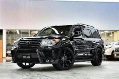 a black suv parked in front of a building