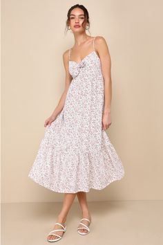 From your crush to your besties, everyone will be complimenting your cute look in the Lulus Decidedly Adorable Ivory Floral Tie-Front Tiered Midi Dress! Lightweight woven fabric boasts an adorably ditsy floral print as it shapes adjustable spaghetti straps and a cute tie-front bodice with a tiny cutout detail and a high, empire-style waist. A-line skirt falls to a twirl-ready tiered midi hem. Smocked panel at back for fit. Fit: This garment fits true to size. Length: Mid-calf length. Size medium Wineries Outfit, Casual Wedding Dress, Ditsy Floral Print, Tiered Midi Dress, Empire Style, Fall Skirts, Your Crush, Ditsy Floral, Dress 100