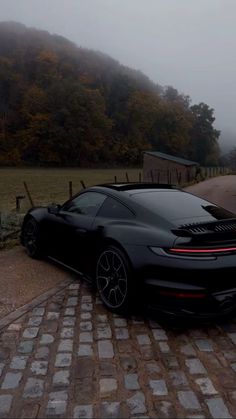 a black sports car parked on the side of a road