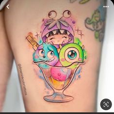 an image of a woman's thigh with ice cream and cartoon characters on it