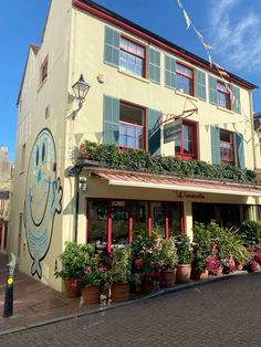 the building has many plants in front of it