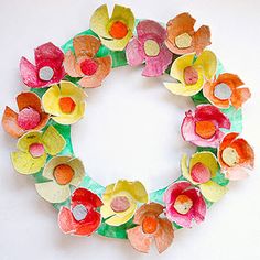 a paper flower wreath on a white wall