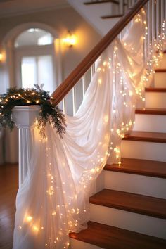 the stairs are decorated with lights and garland