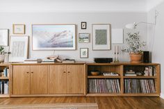 a living room filled with furniture and pictures on the wall