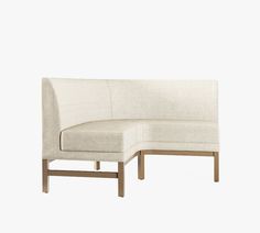 a white couch with a wooden frame and back rest