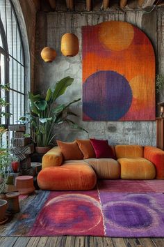 a living room with an orange couch and colorful rugs on the floor next to large windows