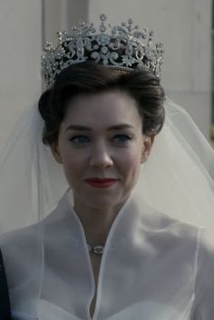 a woman in a wedding dress wearing a tiara