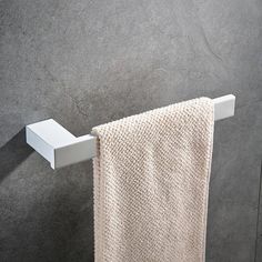 a white towel hanging on the side of a wall