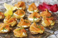 small appetizers with smoked salmon and cream cheese are on a silver platter