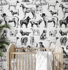 a baby's crib in front of a wallpaper with dogs on it