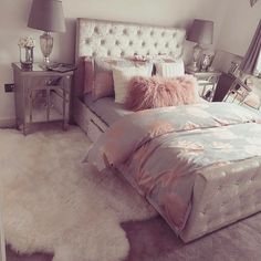 a bedroom with a bed, nightstands and two lamps on either side of the bed