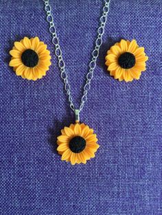 (10,059) Beautiful Sunflower Necklace or Earrings  Made from polymer clay,  7/8" in diameter  Earring on stainless steel posts  Necklace on 18" sterling silver chain Hypoallergenic Polymer Clay Jewelry Gift, Adjustable Hypoallergenic Polymer Clay Jewelry, Nickel Free Flower Polymer Clay Jewelry, Hypoallergenic Dangle Polymer Clay Jewelry, Polymer Clay Jewelry With Flower Charm Gift, Flower Charm Polymer Clay Jewelry For Gifts, Yellow Polymer Clay Jewelry For Gifts, Sunflower Earrings Clay, Nickel-free Polymer Clay Dangle Jewelry