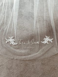 the wedding veil is hanging from the ceiling