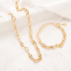 Introducing Tess, an elegant and stylish gold bracelet, featuring an anchor chain that will have all eyes on you. Perfectly crafted to provide a luxurious look and luxurious feel, Tess will complete any outfit and make a lasting impression. Will you make a statement with Tess? Available in 14k gold plated brass Chain width: 6 mm 6" anchor chain with 1" extender Lobster claw closure SKU: BYB1162 Gold Adjustable Chain Bracelet As Fashion Accessory, Gold Chain Bracelet Fashion Accessory, Elegant Yellow Gold Anchor-shaped Necklaces, Elegant Link Charm Bracelet With Chunky Chain, Elegant Chunky Chain Link Charm Bracelet, Trendy Gold Double Chain Bracelet, Elegant Anchor-shaped Jewelry Gift, Elegant Chain Bracelet With Lobster Clasp, Elegant Metal Bracelet With Chunky Chain