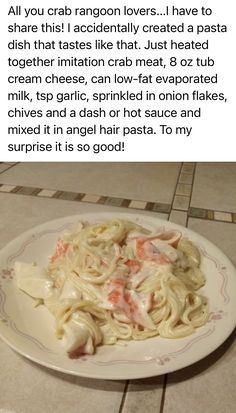 a white plate topped with pasta on top of a tiled floor