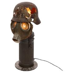 a gas mask on top of a trash can with a light coming out of it