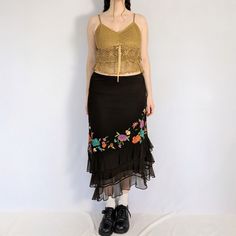 Mesh floral embroidered skirt Stunning brown mesh midi skirt with colourful embroidered flowers on the front. Has a diagonal 3 tiered ruffled hem. Fully lined, has an elastic waistband. Made in the early 2000s by iCe.  Perfect condition  Full measurements are provided Measurements taken flat Tag size: 8 (medium) Waist: 30" - 34" Hip: 40" Length: longest point: 36", shortest point: 29.5" Fabric content: Nylon exterior, polyester lining Spring Lace Bottoms With Floral Embroidery, Fitted Floral Embroidery Tiered Skirt, Spring Floral Embroidery Lace Bottoms, Summer Lace Skirt With Embroidery, Summer Embroidered Lace Skirt, Summer Floral Embroidery Tiered Skirt, Vintage Floral Embroidery Summer Skirt, Midi Skirt Y2k, Mesh Midi Skirt