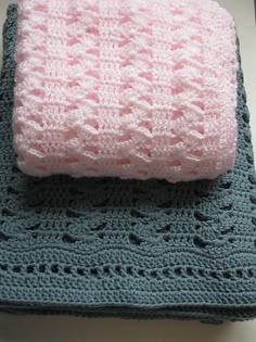 two crocheted blankets on top of each other, one pink and the other green