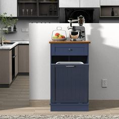 a small blue cart is in the middle of a kitchen