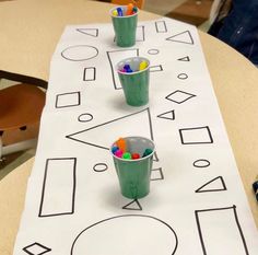 a table with some cups and markers on it