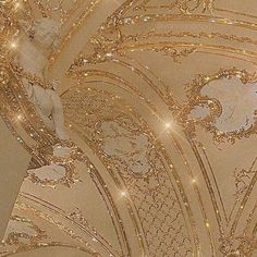 the ceiling is decorated in gold and white