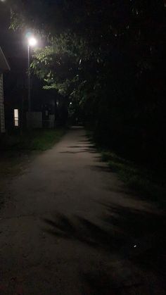 an empty street at night with the light on