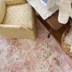 a chair sitting on top of a rug next to a table