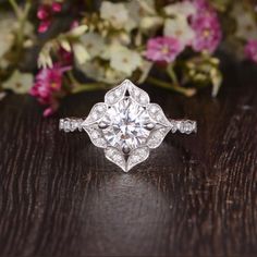 an antique style diamond ring on a wooden table