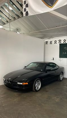 a black sports car parked in a garage