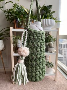 a green crocheted bag hanging from a hook on a wall in a living room