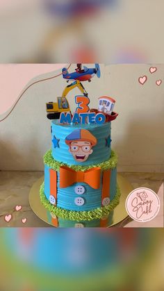 a three tiered birthday cake with an airplane and train theme on it's top