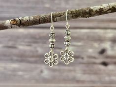 These dainty flower earrings, have a lovely antique silver finish. They are lightweight, and will easily compliment a variety of attire, making them great for everyday wear! Product details: * Silver plated ear wires; Lead and nickel free * Antique silver beads and flower charms * Handmade, with lots of love and care! - Length:   1.3 inches - Width:    .4 inches ❤ You can click here to see more unique jewelry from Flutterbird: https://www.etsy.com/shop/FlutterbirdCo My goal is to provide every c Handmade Sterling Silver Flower Earrings For Her, Handmade Sterling Silver Flower Earrings As Gift For Her, Silver Flower Metal Earrings For Spring, Handmade Sterling Silver Flower Earrings As A Gift, Silver Metal Flower Earrings For Spring, Spring Silver Metal Flower Earrings, Spring Silver Flower Metal Earrings, Silver Flower Earrings As Gift For Her, Delicate Silver Earrings With Flower Charm