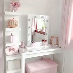 there is a vanity with a mirror and stool in the room that has pink accessories on it