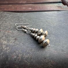 These simple earrings are made each with five sterling silver beads, in a traditional and versatile style intended to go with anything from a squash blossom necklace to simple Navajo Pearl necklace. The beads are graduated in size and so very well made saucers, the seams well-smoothed and the patina gorgeous. The earrings are not large, and I love that about them, as silver bead earrings are so hard to come by, and especially in a more subdued size such as this. That is not to say they are small Southwestern Style Silver Round Bead Jewelry, Nickel-free Southwestern Drop Earrings, Native Necklace, Southwestern Style Red Nickel-free Earrings, Southwestern Style Nickel-free Brown Earrings, Silver Bead Earrings, Nickel-free Turquoise Southwestern Earrings, Native American Earrings, Native American Rings