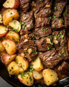 steak and potatoes in a skillet with parsley sprinkled on the side