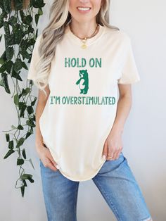 Hold On, I'm Overstimulated, Unisex Graphic Tee, Funny Bear T Shirt, Oversized Tee Shirt, Comfort Colors® Shirt, Funny T Shirt, Meme Shirt  F I T ∙ & ∙ S I Z I N G : -->These Unisex T-shirts have a modern-fit. Consult the size chart in the pics for an accurate fit. -->Women's sizes are narrower than the waist. -->Sleeves are rolled up in some product pictures. They do not come rolled up on delivery. T I M E ∙ T O ∙ D E L I V E R Y : -->Processing and production time is 1-2 business days. -->Deli Shirt Quotes, Oversized Tee Shirt, Funny Bears, Comfort Colors Shirt, Bear T Shirt, T Shirt Oversized, Product Pictures, Funny T Shirt, Oversized Tee