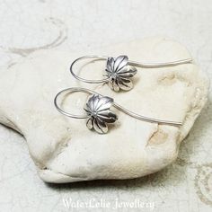 "Silver Flower Earrings. Silver Bellflower earrings. Petal earrings. Flower hoops. Minimalist earrings. Nature Jewelry. Bluebell earrings -------------- I designed these bell flower earrings from 19g Argentium silver and the flower head is sterling silver. The earrings thread through the ear and the flower dangles in front. Very elegant but whimsical. They measure about 1 3/8\" long. Note that mannequin is not life size. Shipped with rubber stoppers in a gift box. For more modern silver jewelry: Delicate Small Hoop Earrings With Ear Wire, Adjustable Flower Hoop Earrings For Everyday, Minimalist Everyday Flower Charm Earrings, Delicate Flower Charm Hoop Earrings, Delicate Flower Charm Earrings For Everyday, Minimalist Flower Shaped Earrings With Ear Wire, Minimalist Flower Shaped Jewelry With Ear Wire, Minimalist Flower Shape Ear Wire Jewelry, Minimalist Adjustable Flower Earrings As Gift