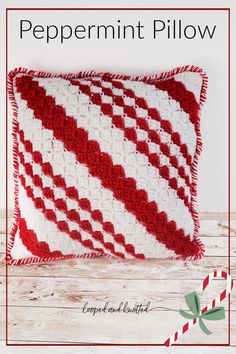 a red and white crocheted pillow with the words peppermint pillow on it